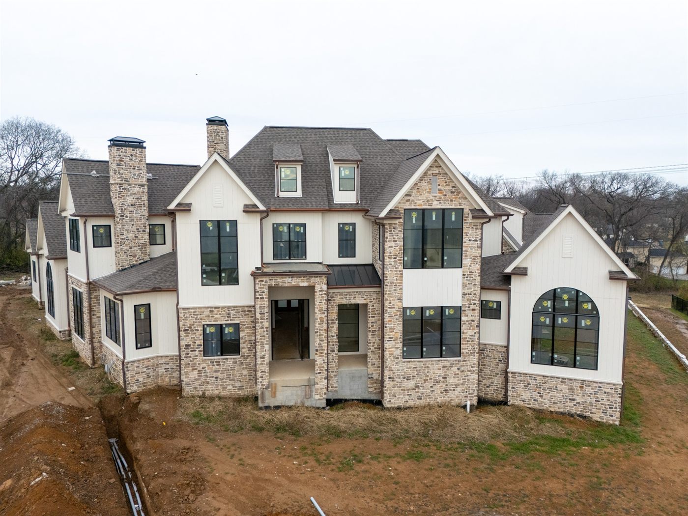 Front elevation with stone and white brick gables